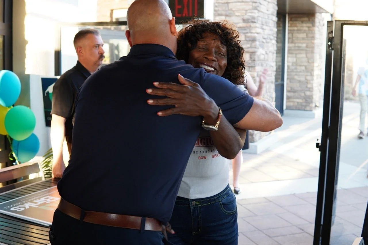 Mayor Acquanetta Warren hugging 
Anthony Vega, Police Chief, City of Colton.