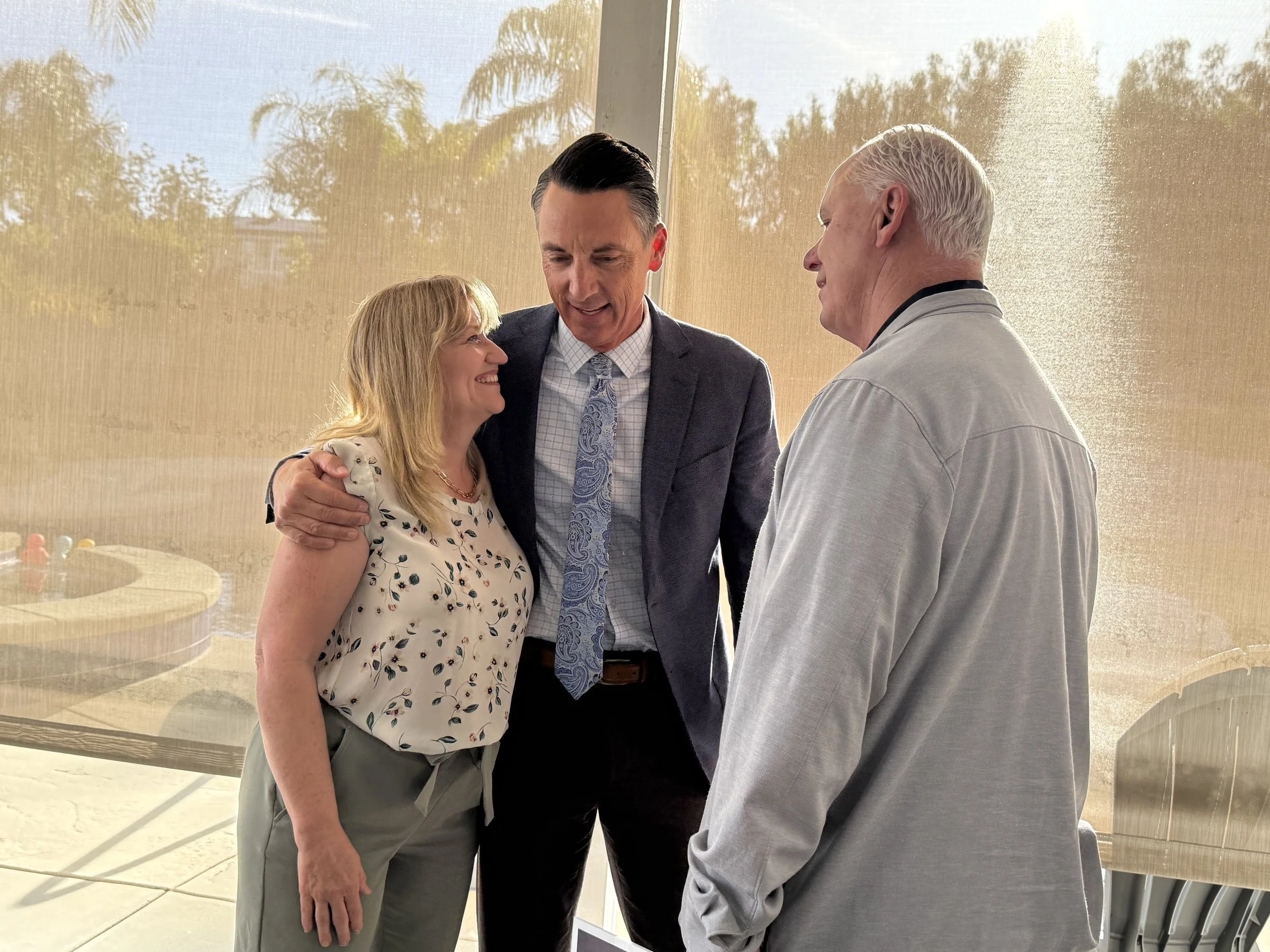 Two adults speaking with Cali