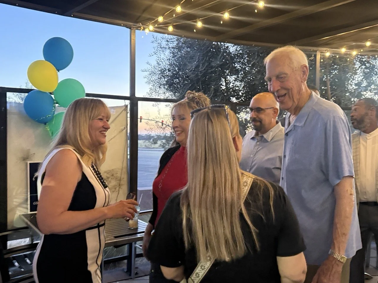Cali speaking to Dr. Herb Fischer and two guests.