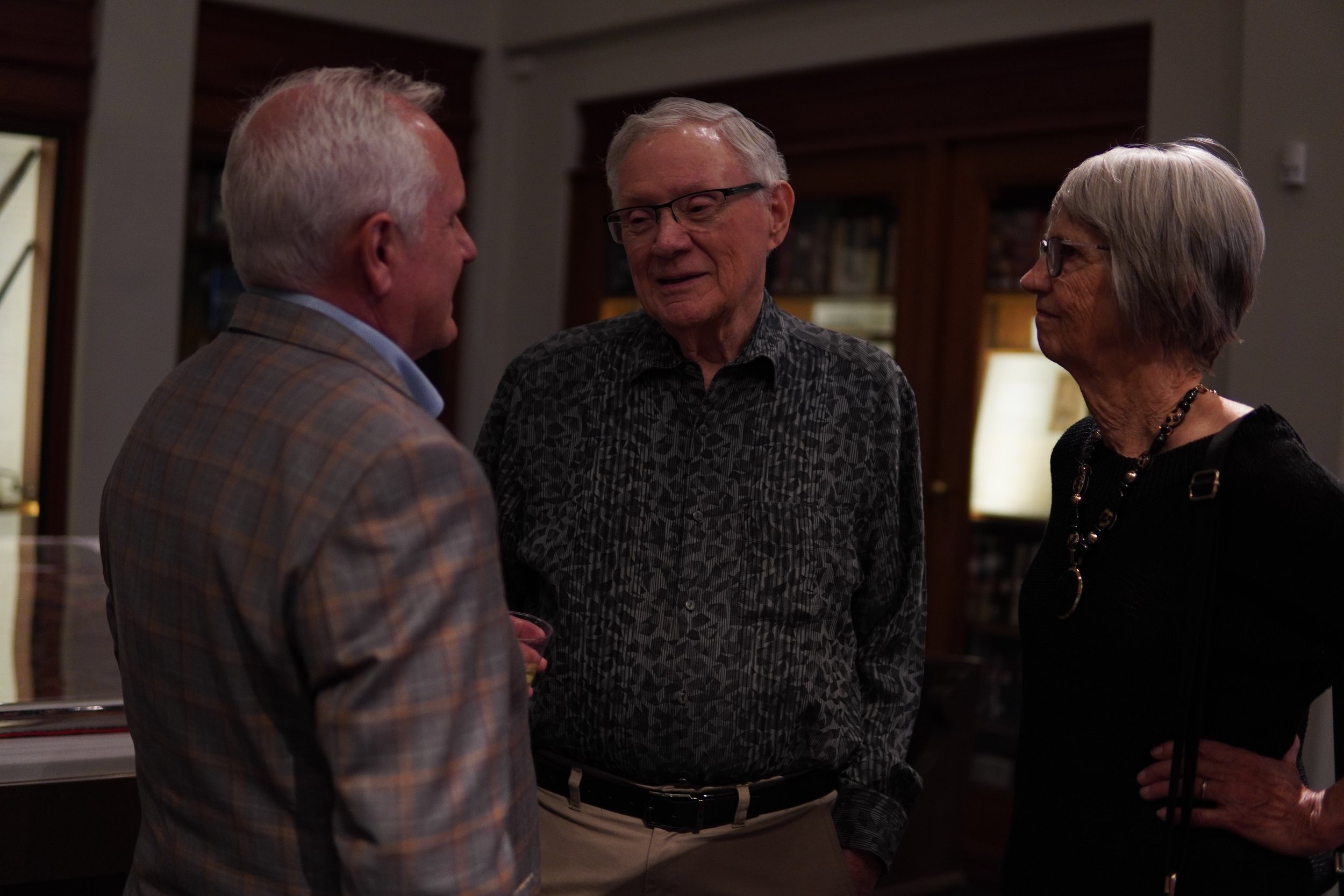 Neal speaking to two adults