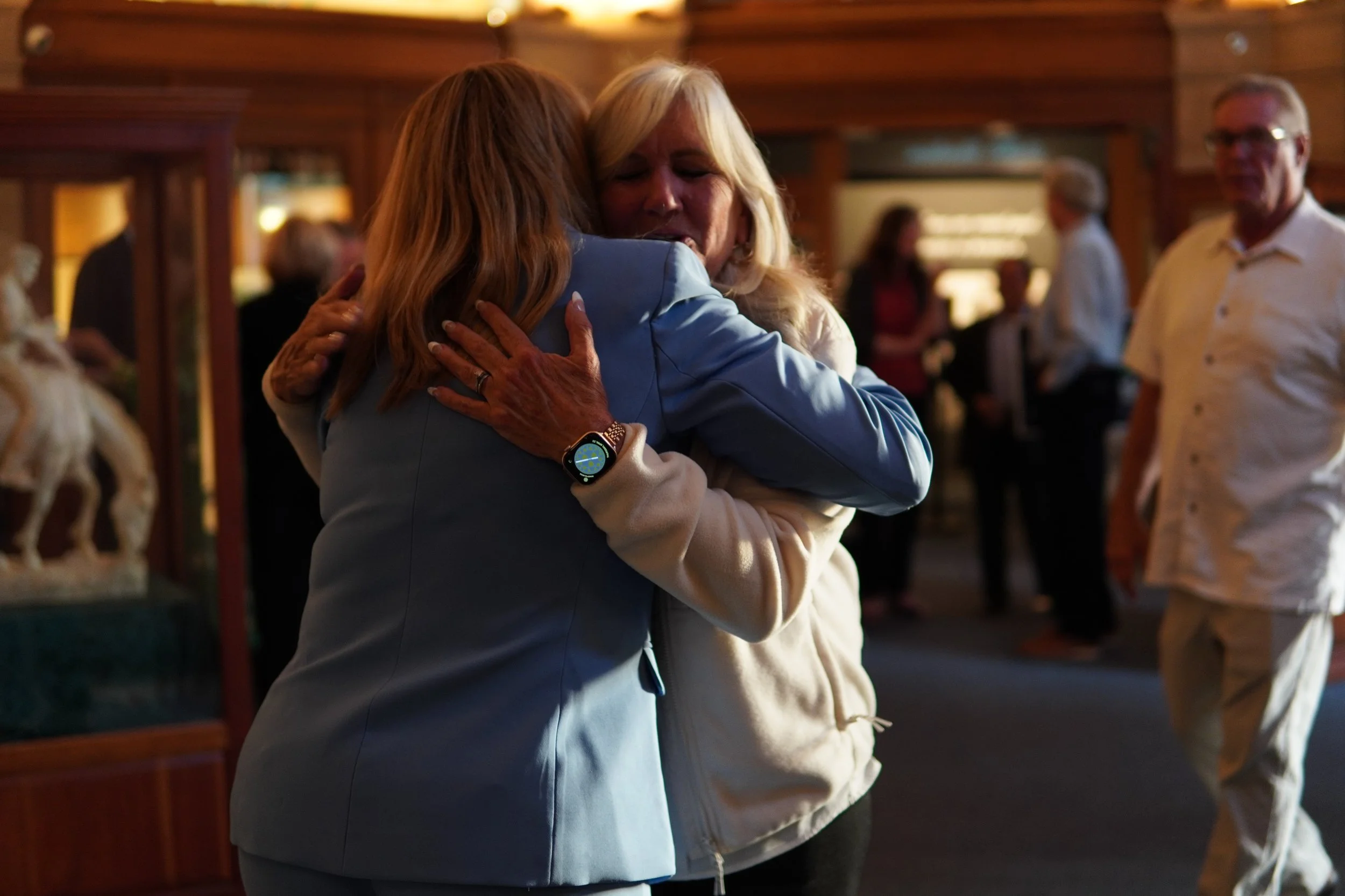 CAli hugging a community member