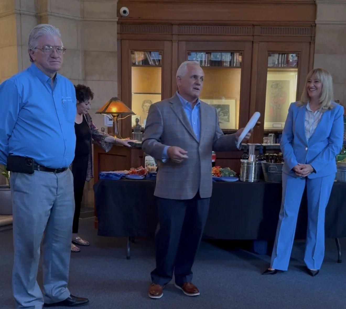 Neal next to Cali speaking to the guests