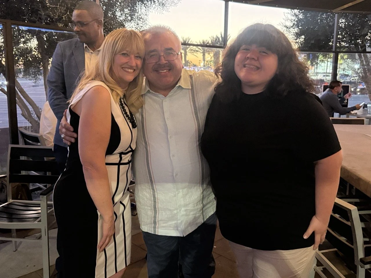 Cali posing and hugging Israel Fuentes, Colton Joint Unified School District Board Member and daughter.