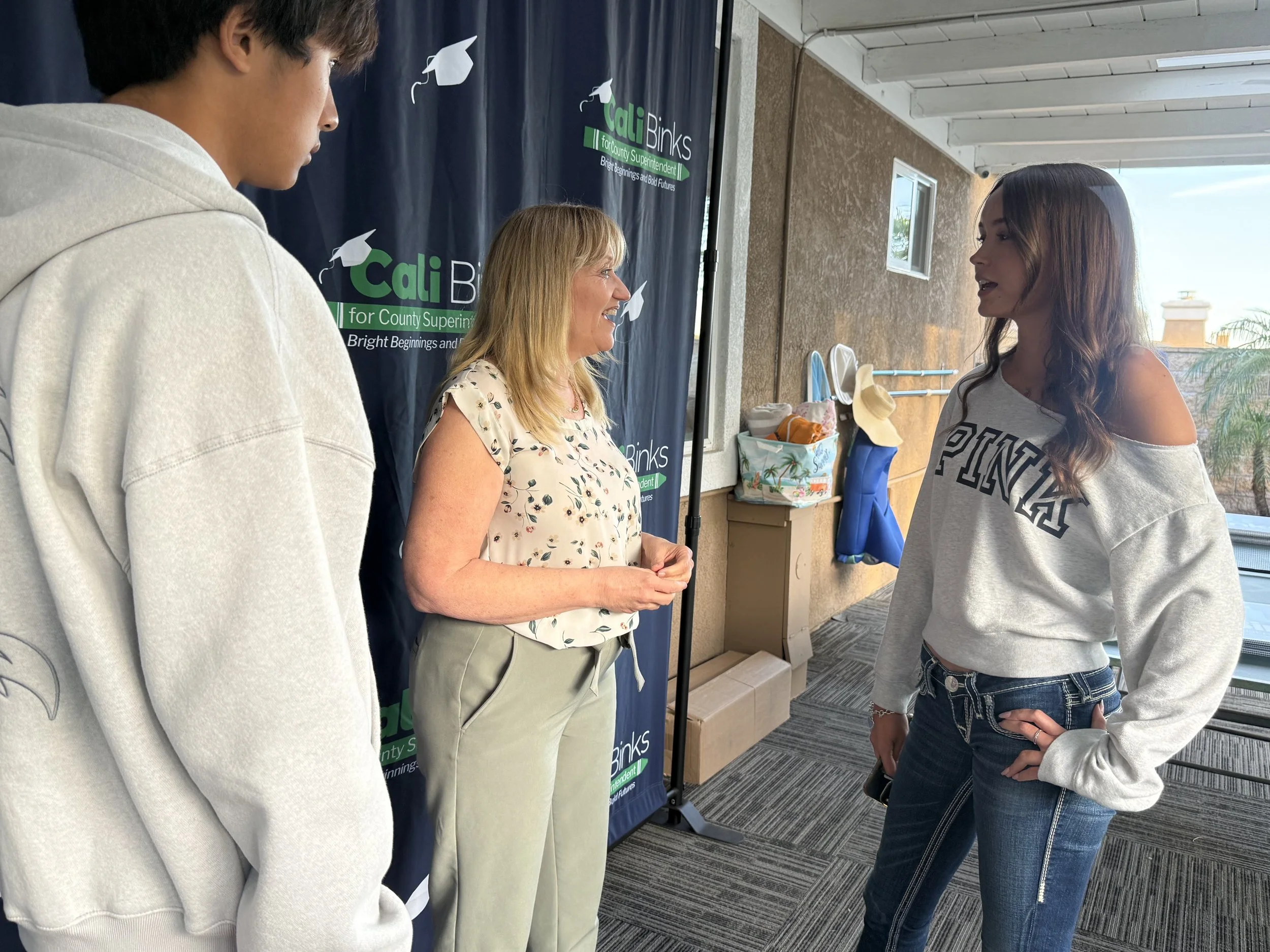 Cali speaking with two high school students