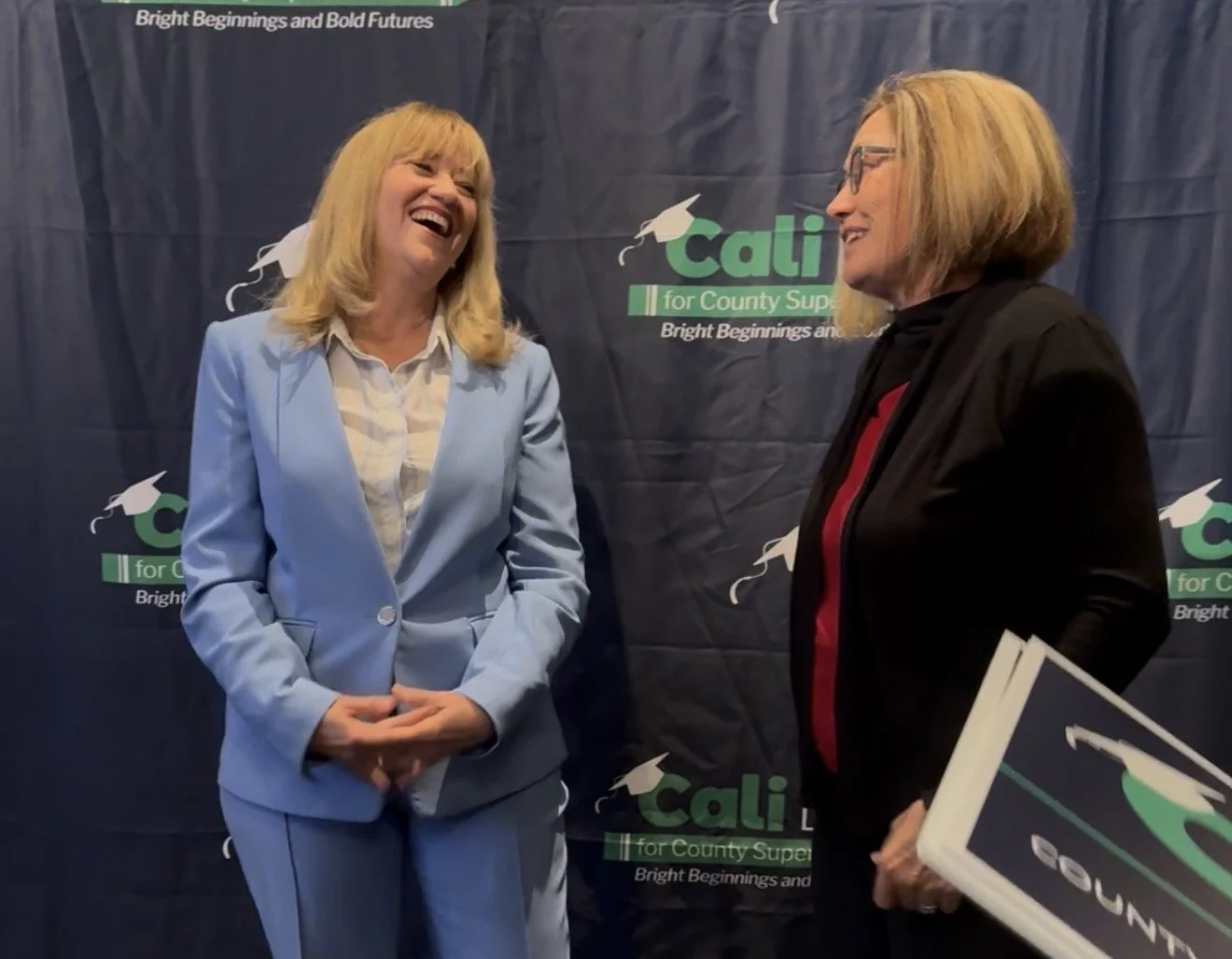 Cali Binks speaking and laughing to a community member