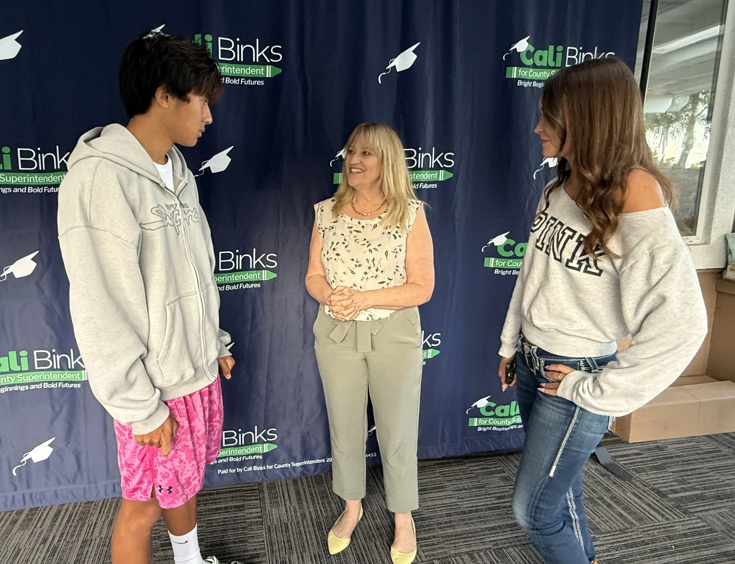 Cali speaking with two high school students