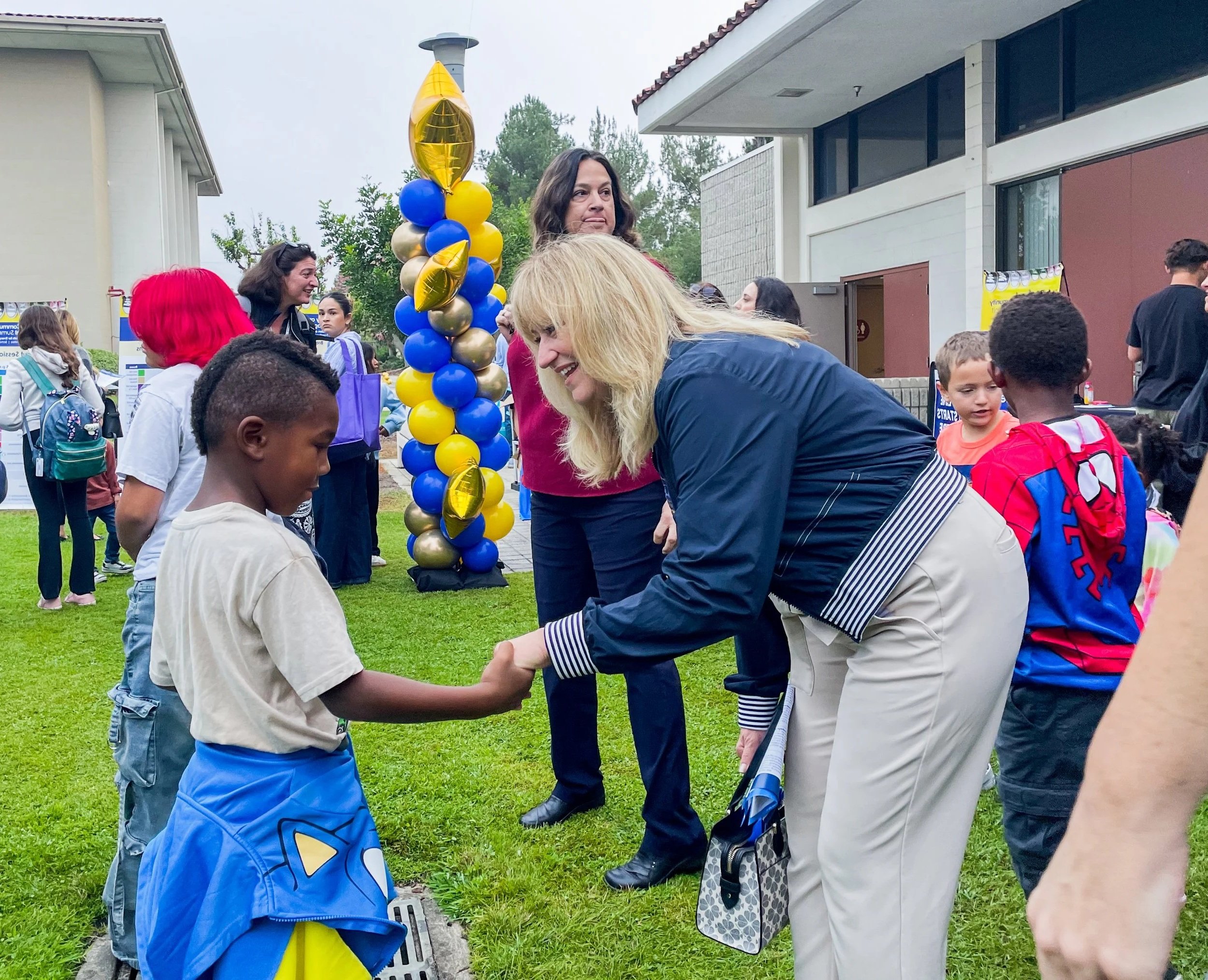 Cali shaking a student's hand.