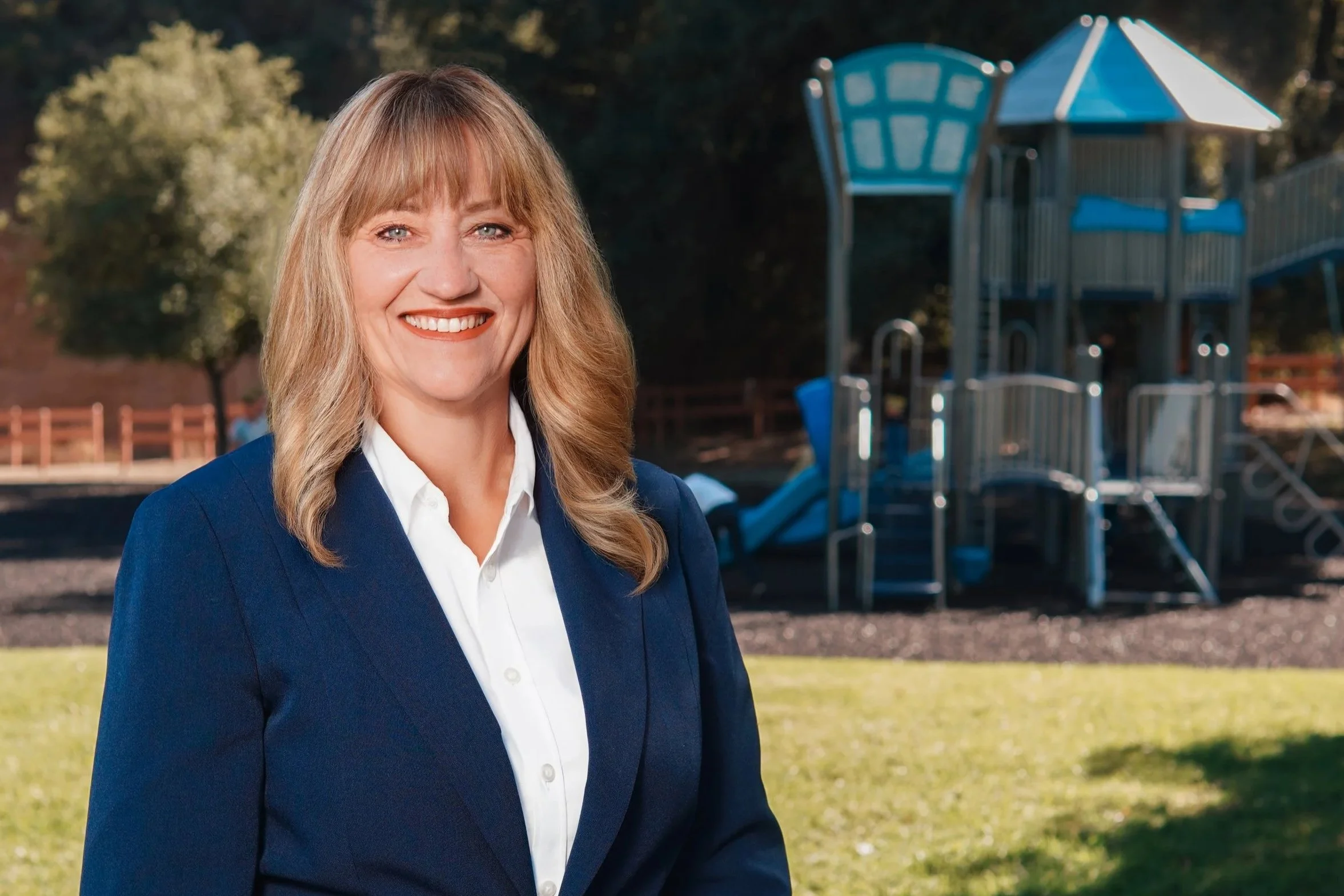 Cali posing in front of a playground structure.