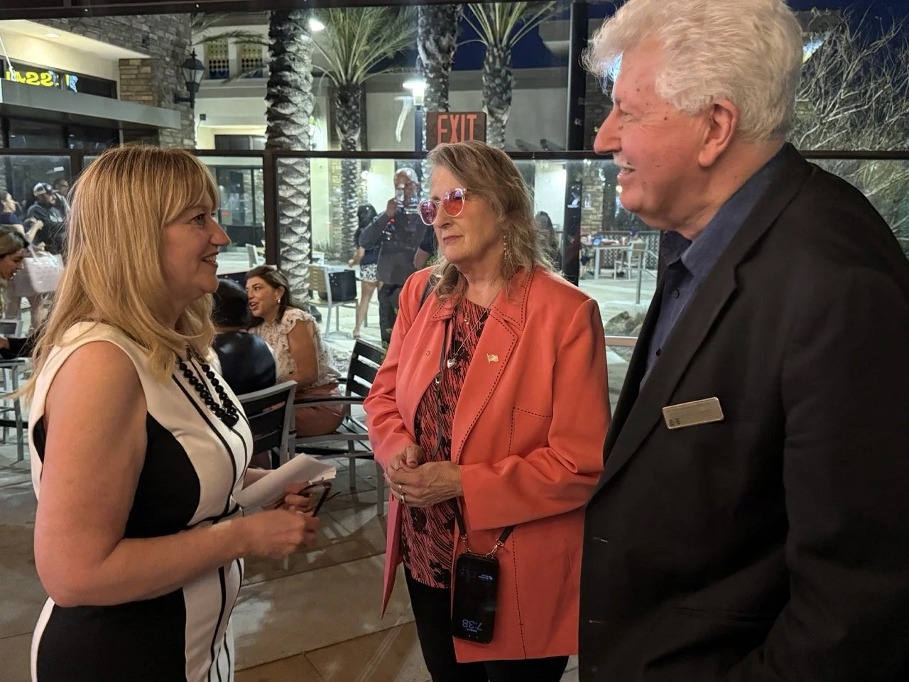 Cali speaking to Eric Swanson and guest.