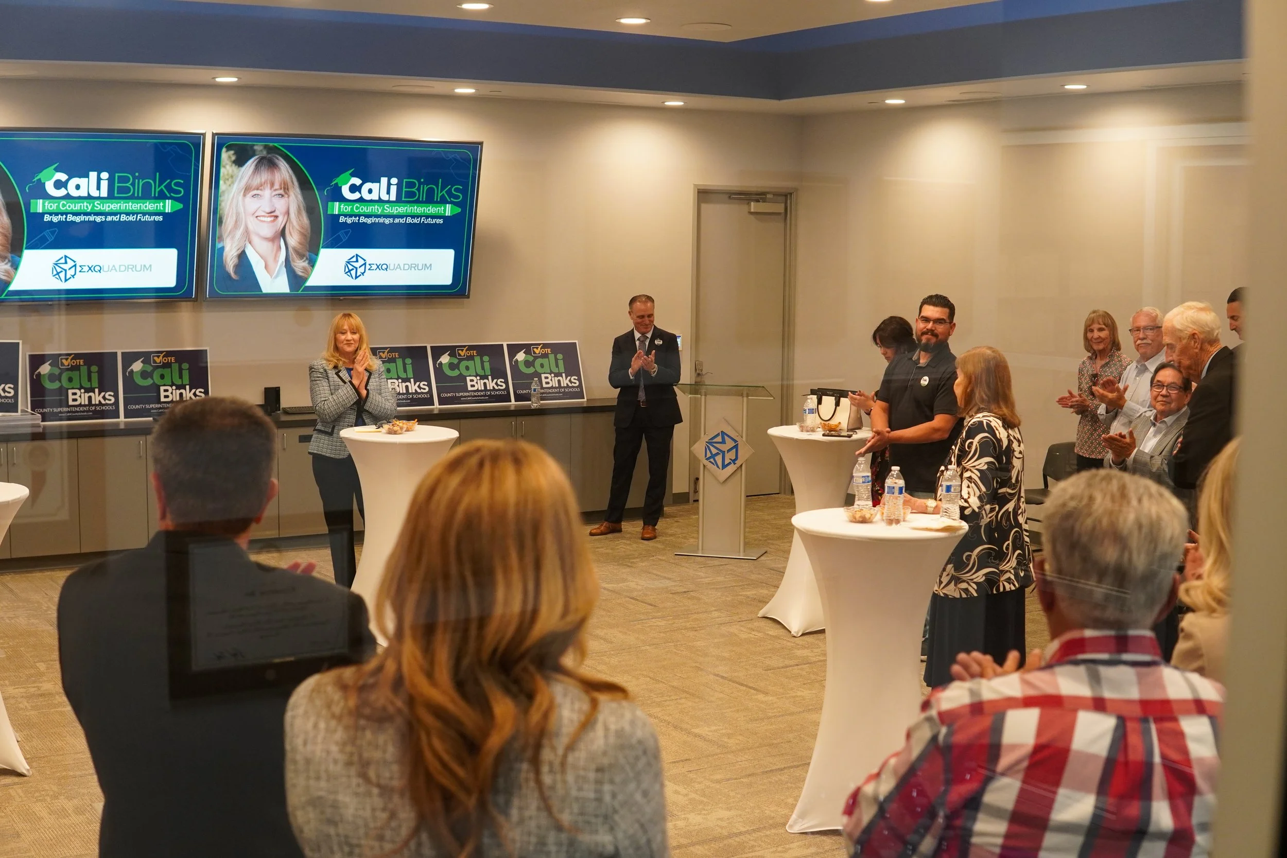 Group of adults listening to Cali Bink speak.