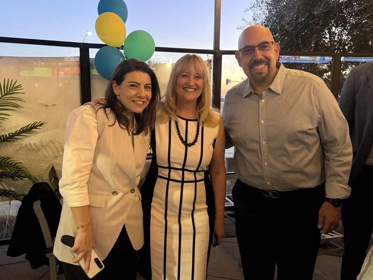 Cali posing with Angela Khoury and husband.