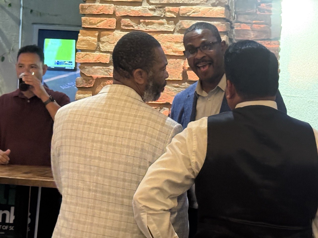 Two community members speaking to Dr. Scott Wyatt.