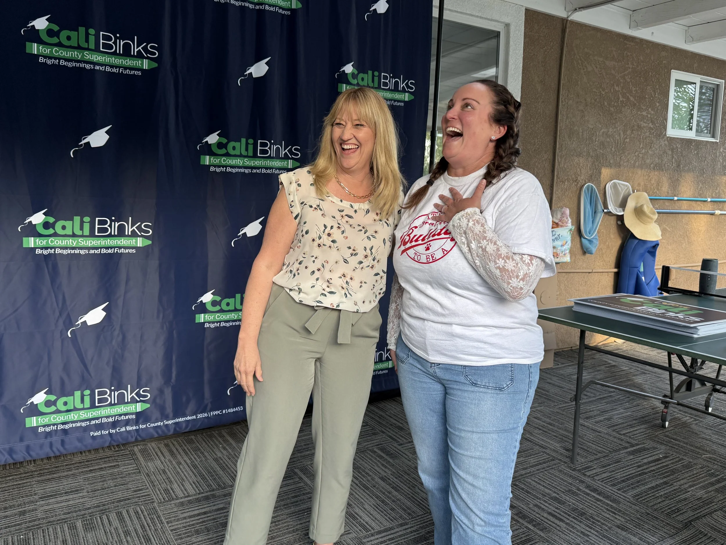 Cali laughing with a community member
