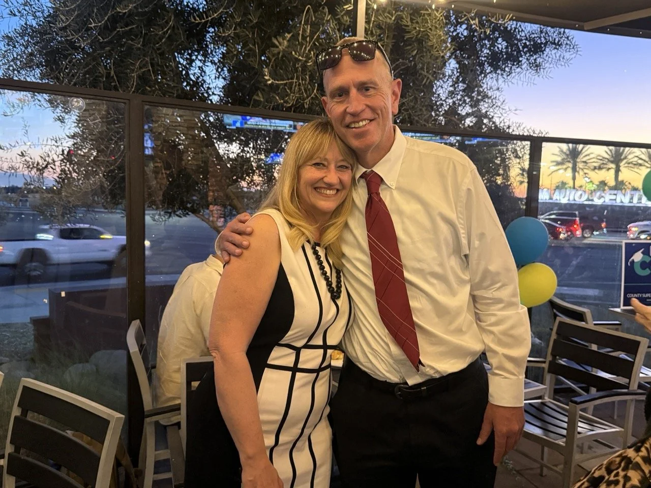 Cali hugging and posing with guest.