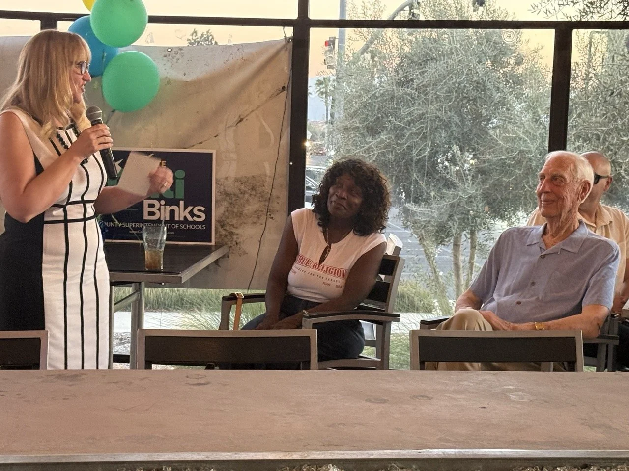 Cali speaking to the event guests.