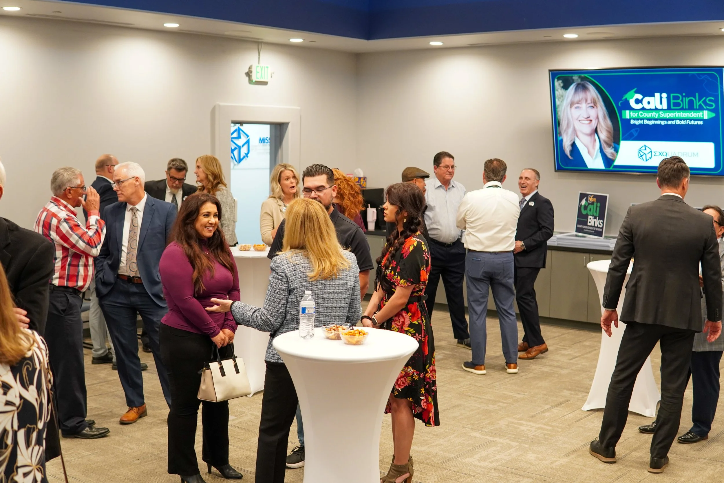 Community members networking with Cali.