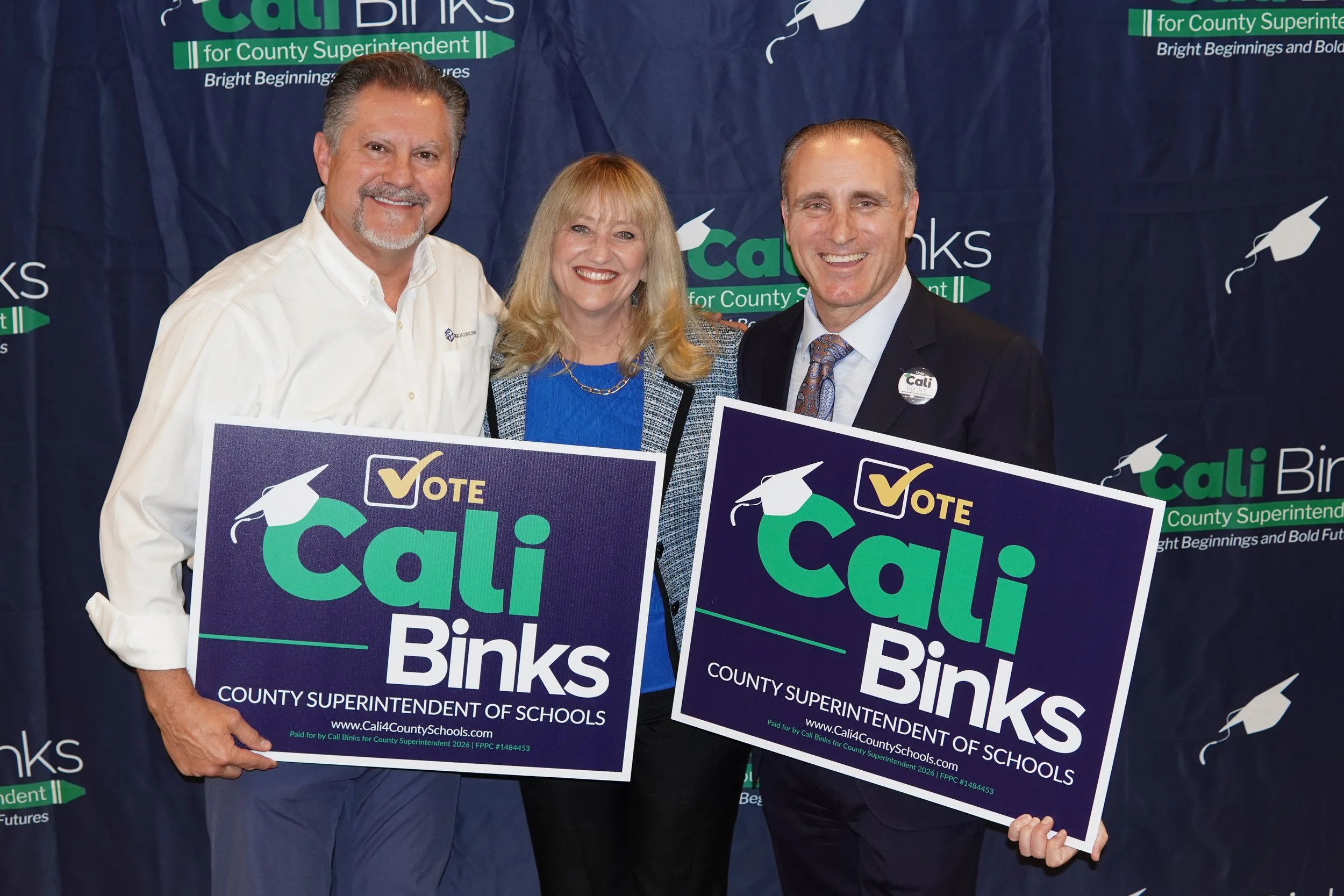 Eric Schmidt, President of Exquadrum Inc. and Ryan McEachron, Trustee of San Bernardino County Board of Education holding yard signs with Cali Binks.