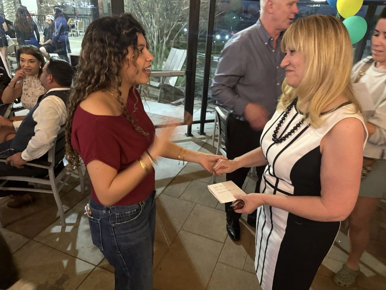 Cali speaking to former student from Los Osos High School.