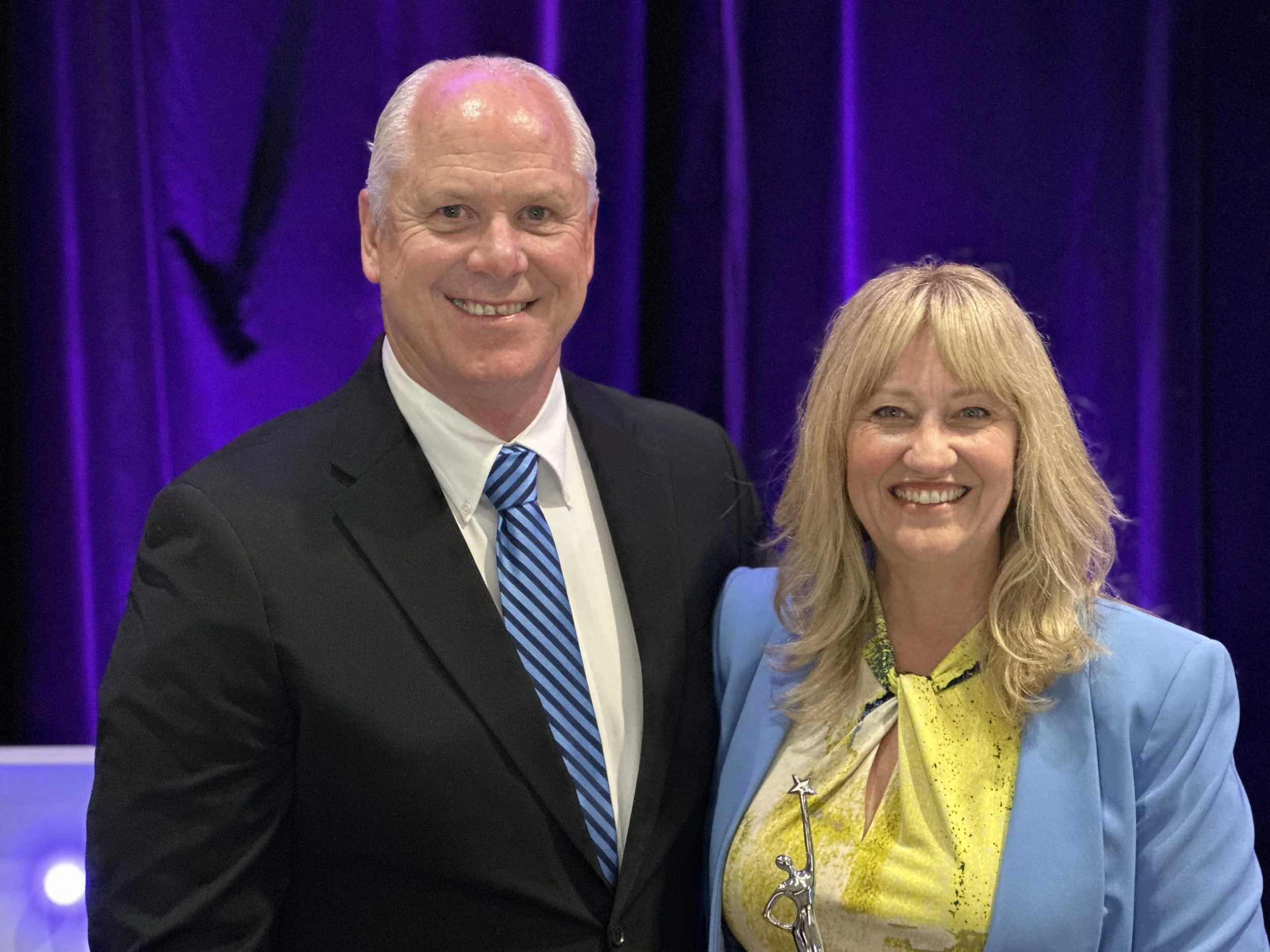 Cali standing next to her husband.