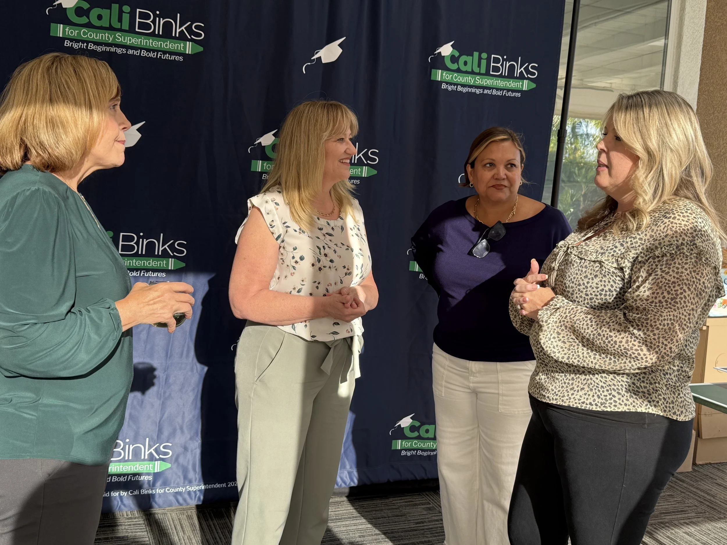 Three community members speaking with Cali