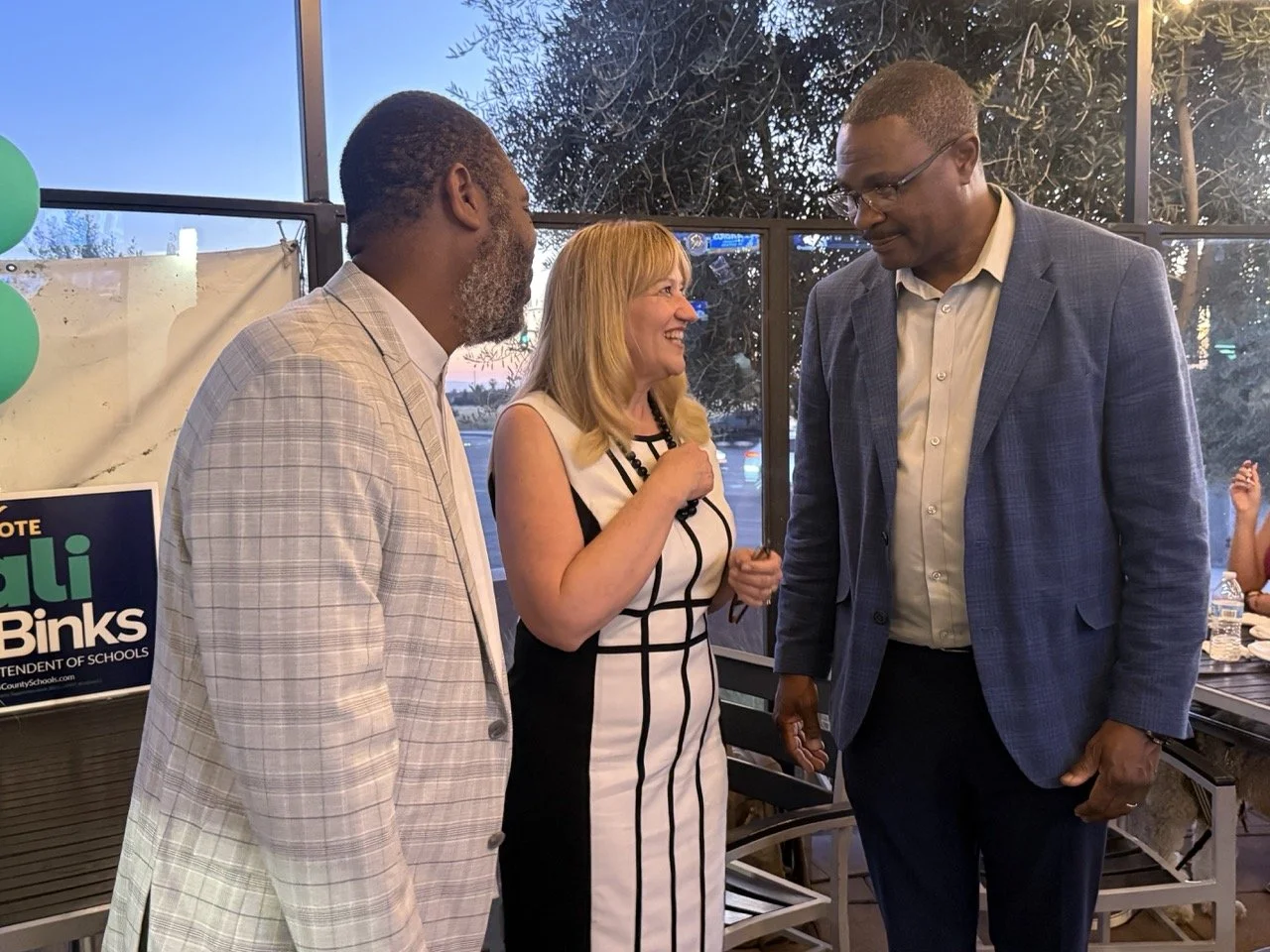 Cali networking with two guests.