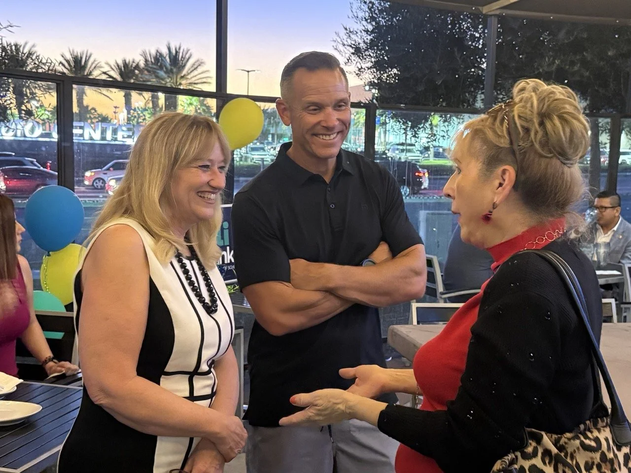 Cali networking with two community members and guests.