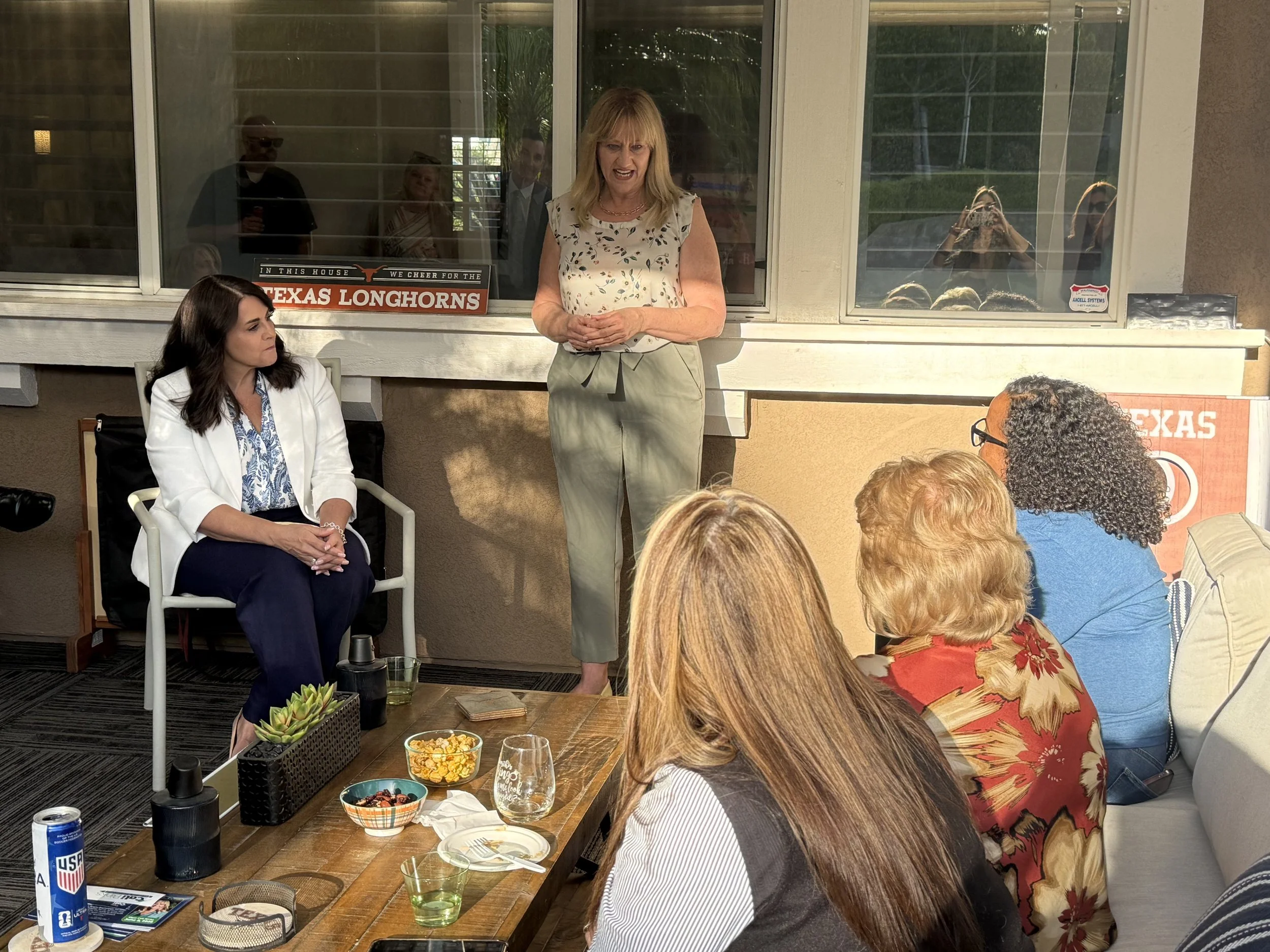 Cali speaking to a crowd of community members