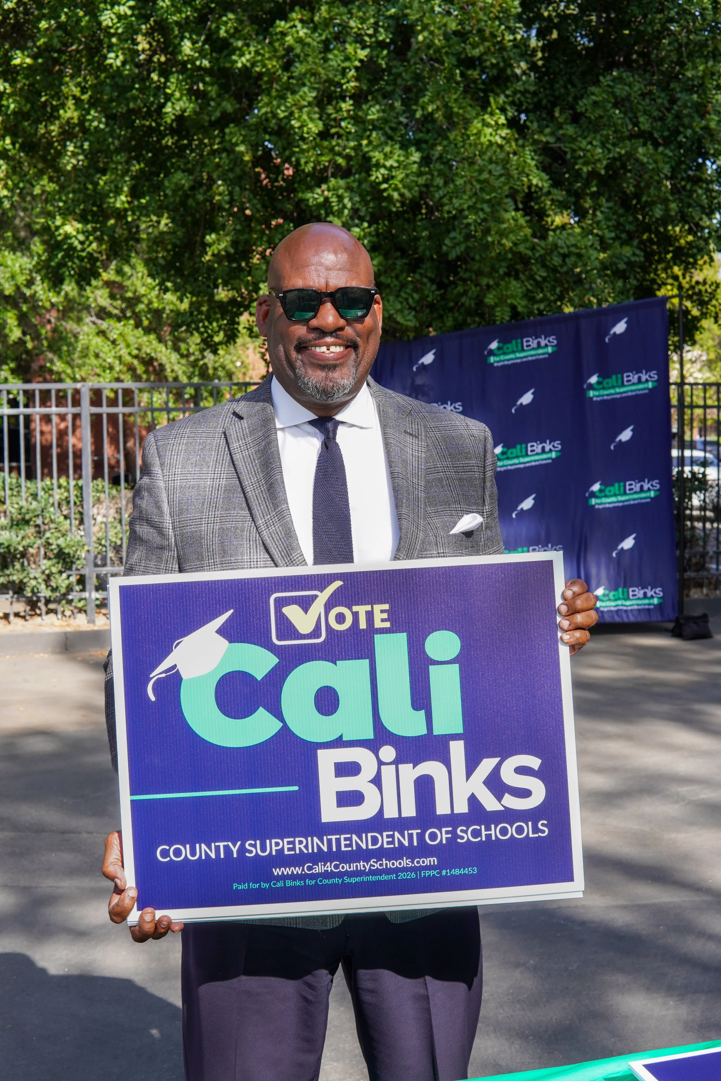 Adult holding a yard sign.