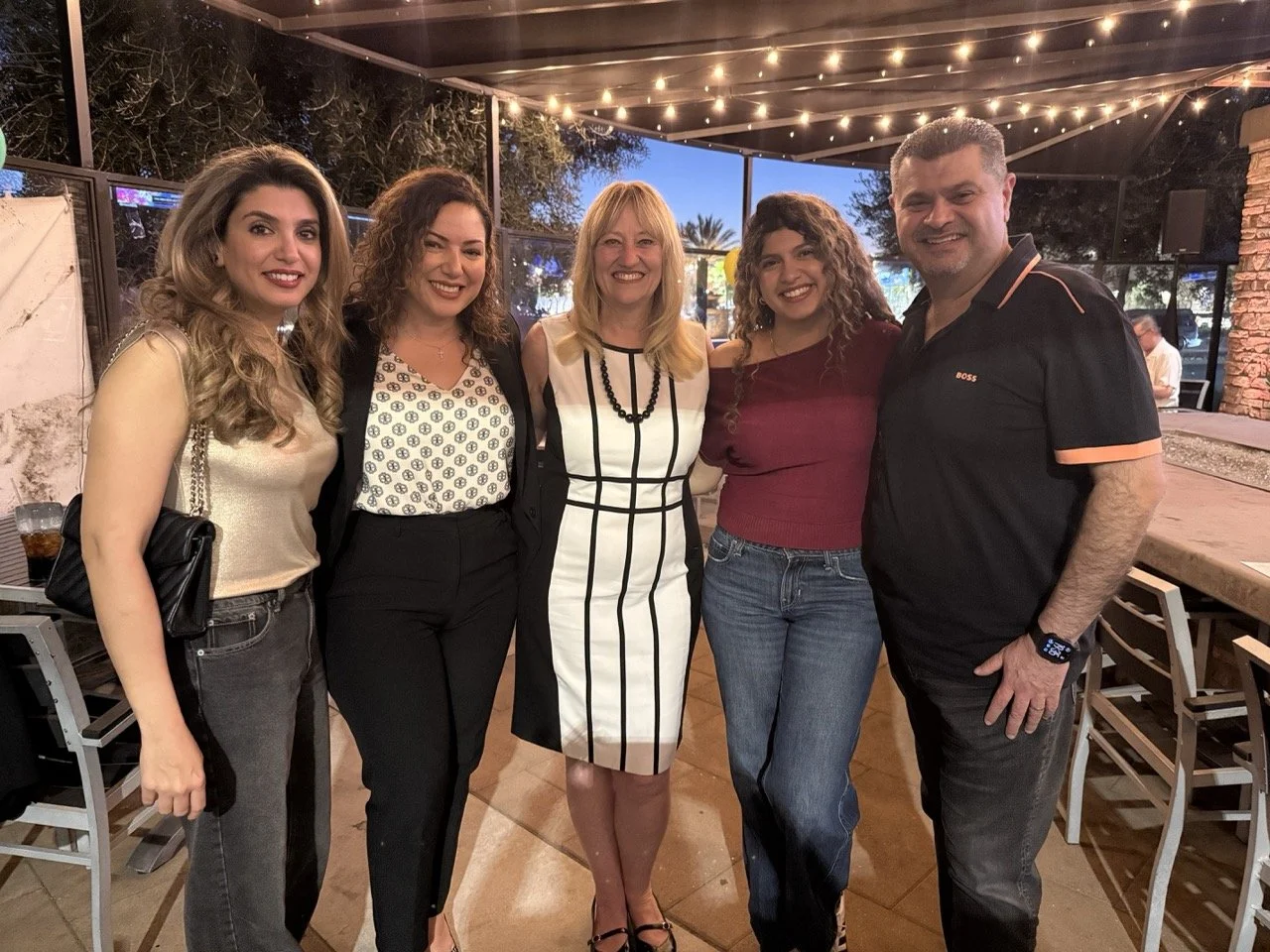 Cali posing with family of three and Lisa Garcia.