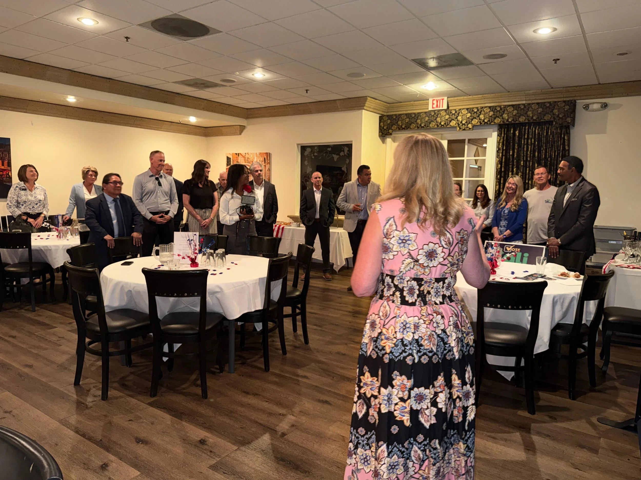 Cali Binks speaking to guest at the fundraiser.