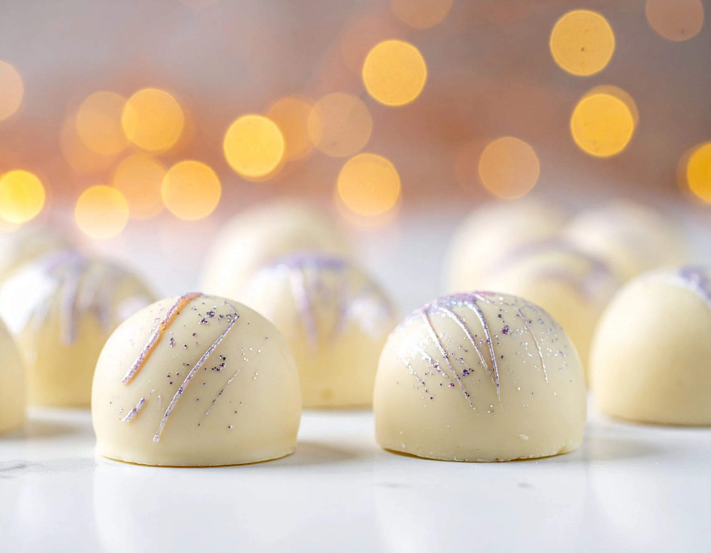Firefly_white chocolate bonbons painted with sparkles 831711.jpg
