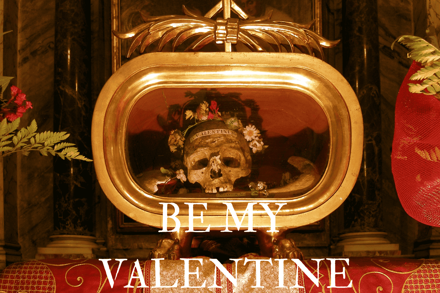 Image of the Skull of St Valentine adorned with a Flower Crown inside a golden vitrine with the words "Valentini" on the forehead and the title "Be My Valentine" of the article published in Issue 02 of The Lonely Hearts Club at the bottom.