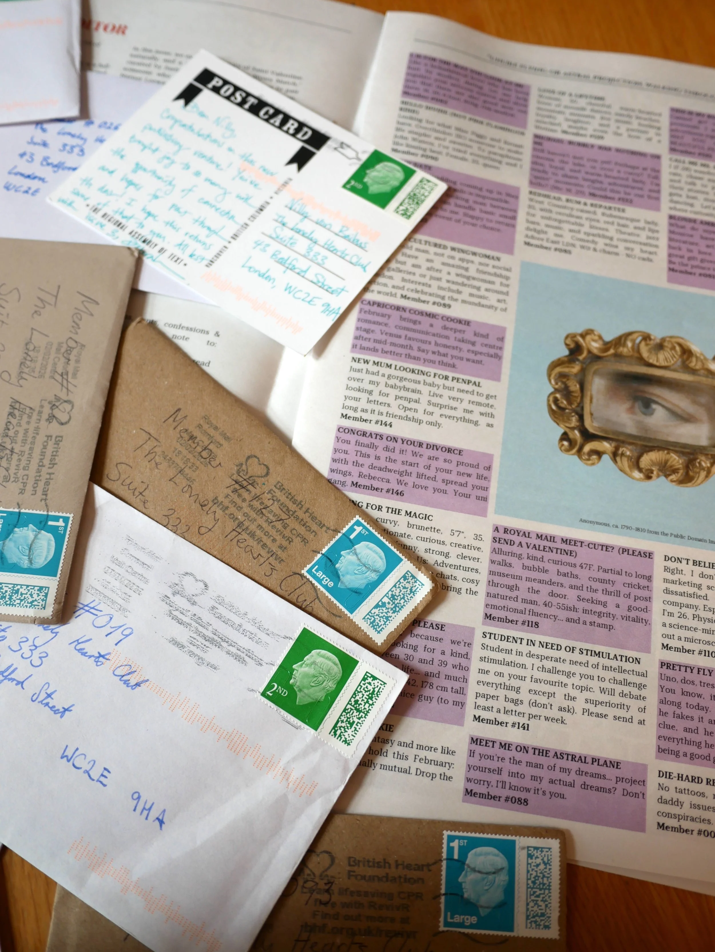 Various letters and postcards stewn across the personal ads page of The Lonely Hearts Club Newspaper Issue 02