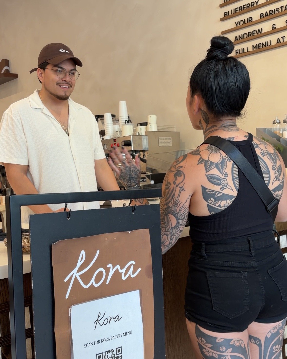 Kevin, co-founder of Kora, and Jules talking at the cafe counter