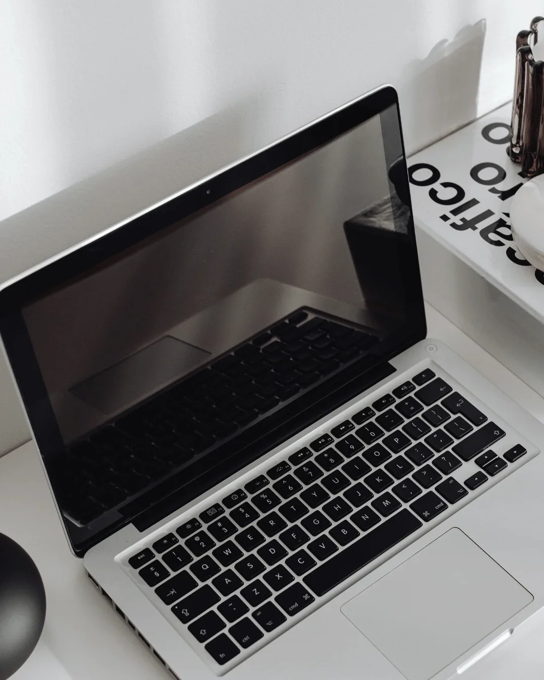 Open laptop on a modern white desk representing digital marketing and online business strategy.