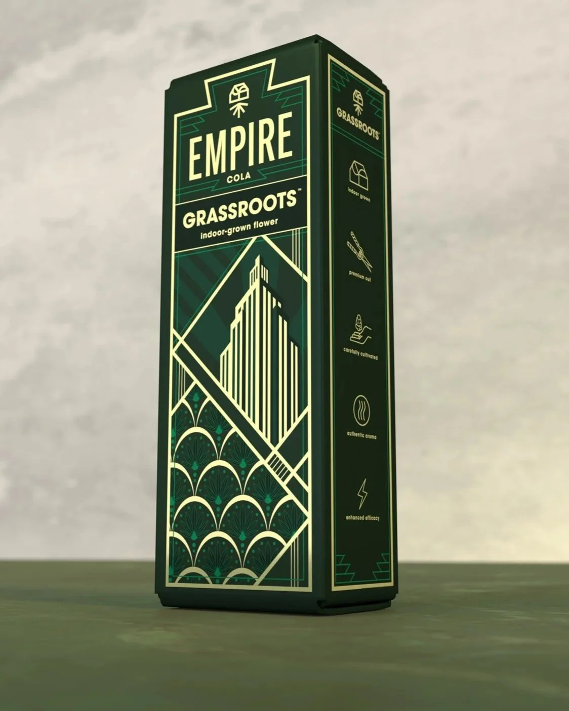 A tall, rectangular box of Empire Cola Grassroots, an indoor-grown flower product, with Art Deco design elements and icons indicating its features such as being grown indoors, pre-rolled, carefully curated, with authentic aroma and advanced efficacy.