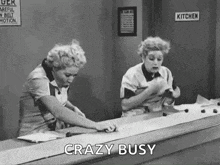I Love Lucy! Two women working hard at a conveyor belt, looking busy and focused.