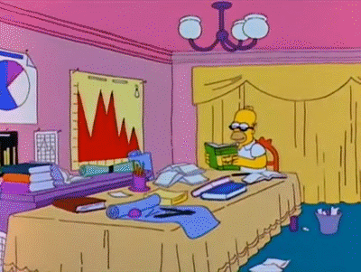 The Simpsons living room with Homer reading a copy of "Advanced Marketing" at a cluttered table.