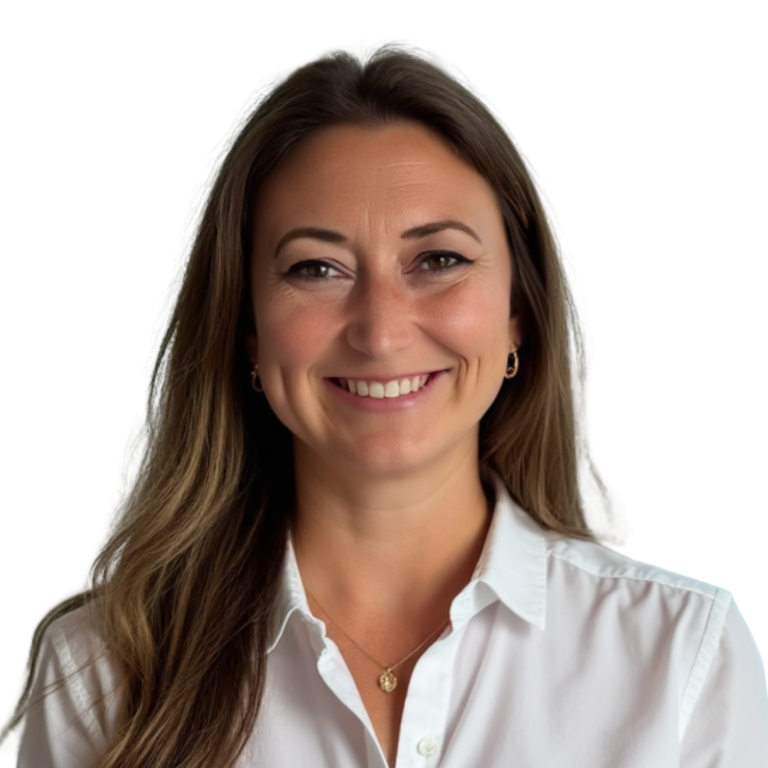 Portrait of a woman with long brown hair, smiling, wearing a white button-up shirt and gold jewelry with a plain white background.