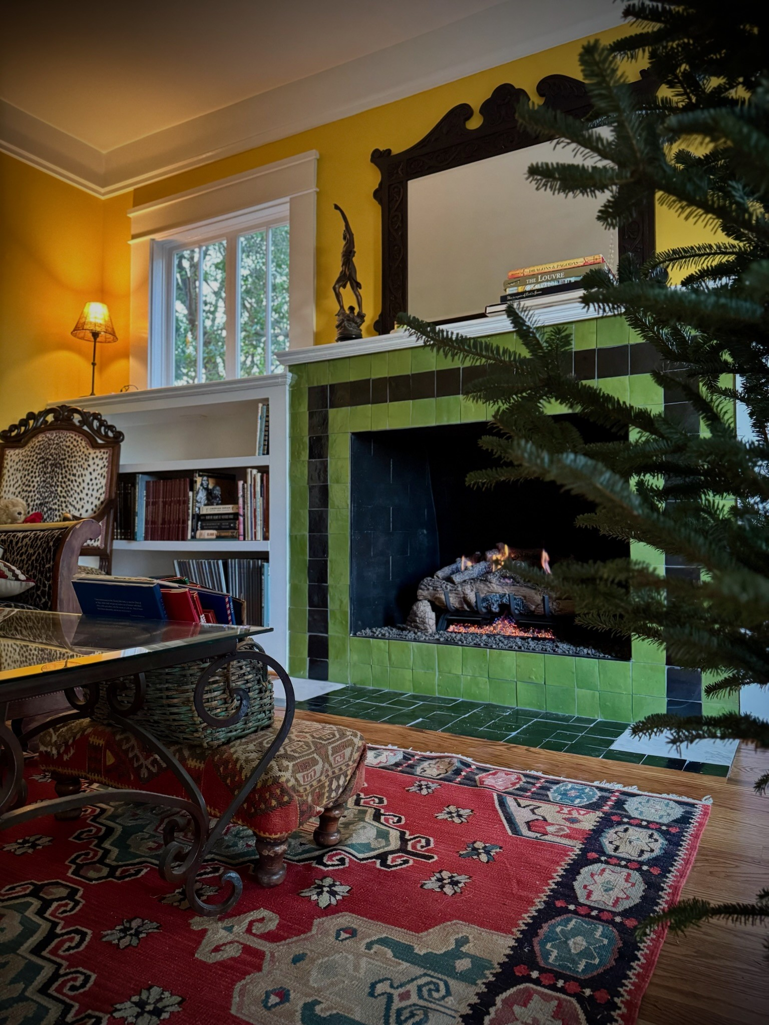 Character-rich living space featuring a handcrafted tiled fireplace, thoughtfully framed to maintain the home’s rustic charm and original architectural character.