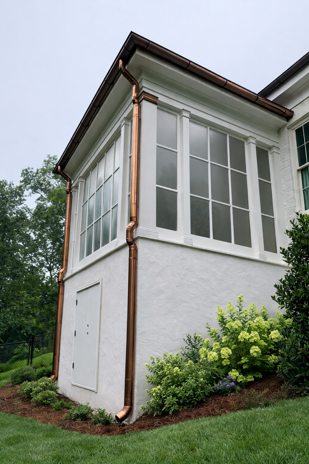Custom copper gutter installation integrated with smooth stucco and architectural trim, showcasing durable craftsmanship and an elevated exterior finish. 