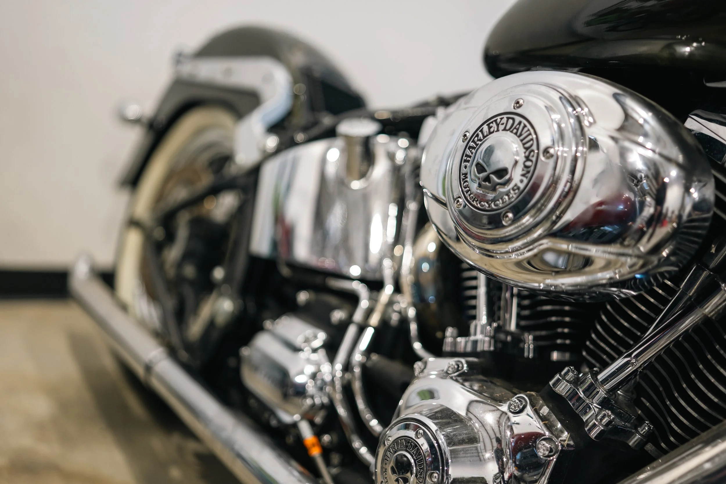Close-up of a shiny Harley-Davidson motorcycle engine showing detailed chrome parts.