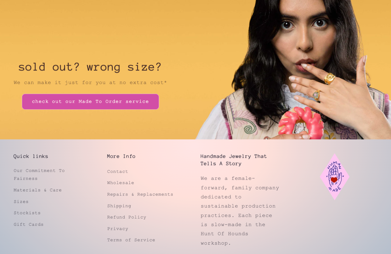 A woman with dark hair making a shushing gesture with her finger to her lips, holding a pink frosted donut in her other hand, standing against a yellow background with text about custom jewelry and a pink button for made-to-order service.