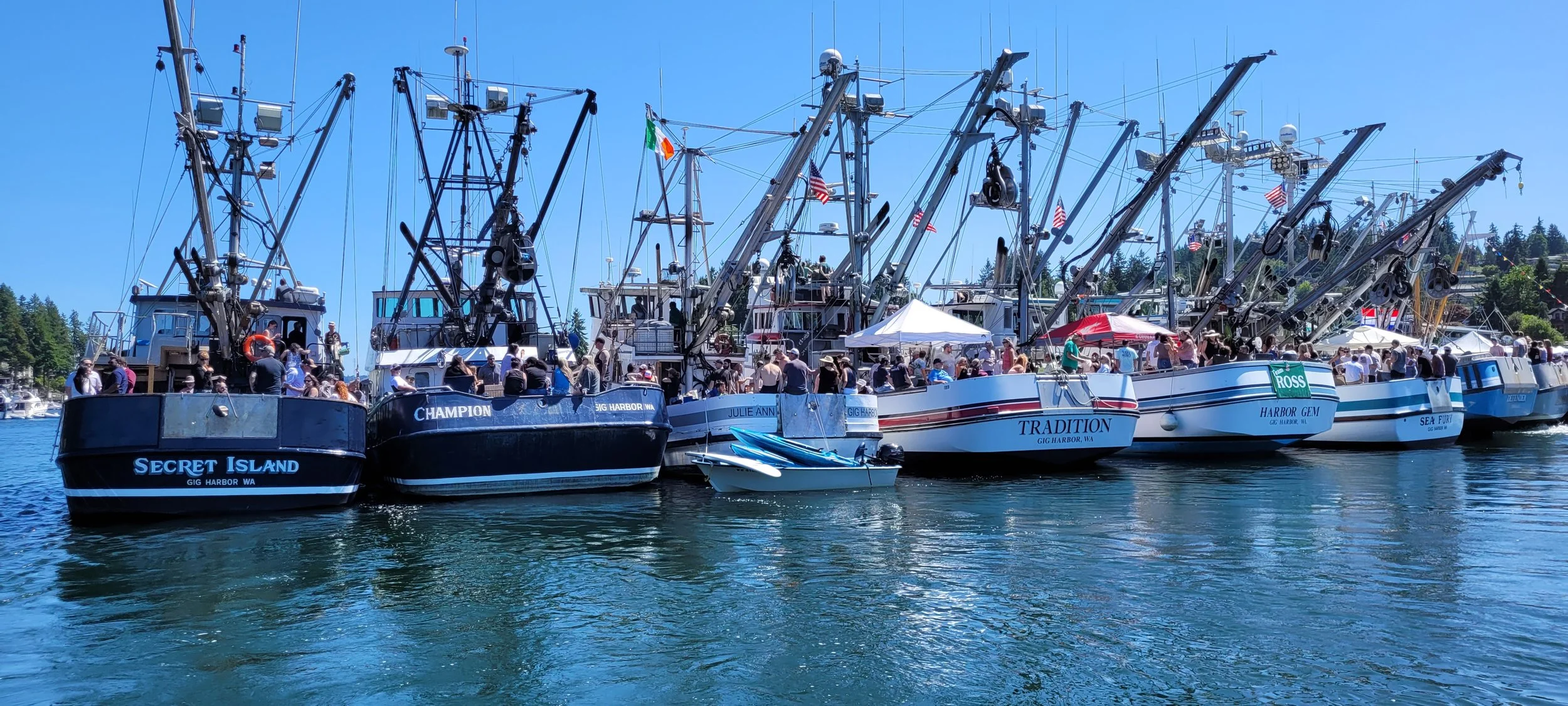 The Gig Harbor fishing fleet seen at the annual Blessing of the Fleet, photgraphed by Peter Glein, a local expert on boating, real estate, and waterfront living.
