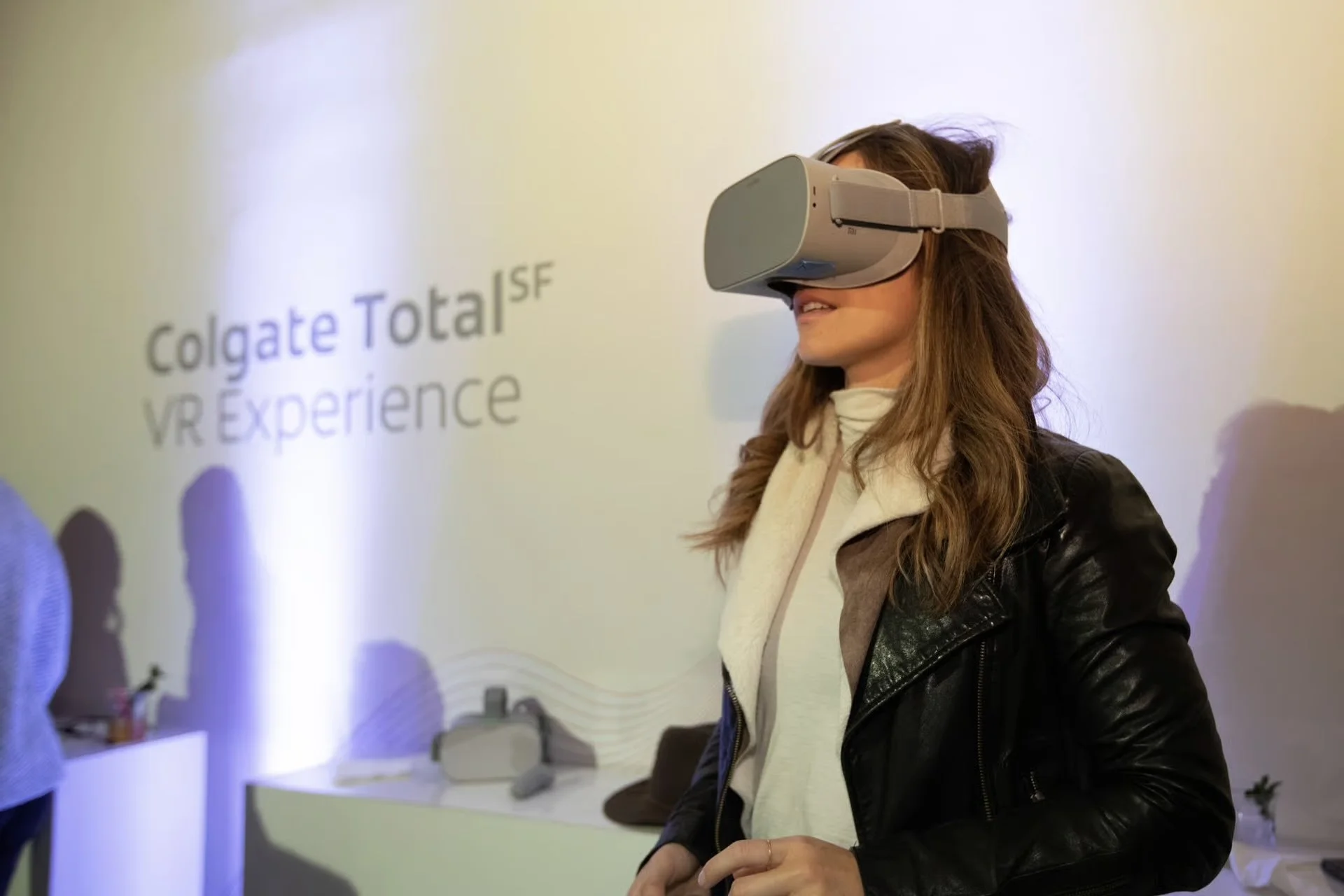 Woman wearing a VR headset at Colgate Total SF VR experience event.