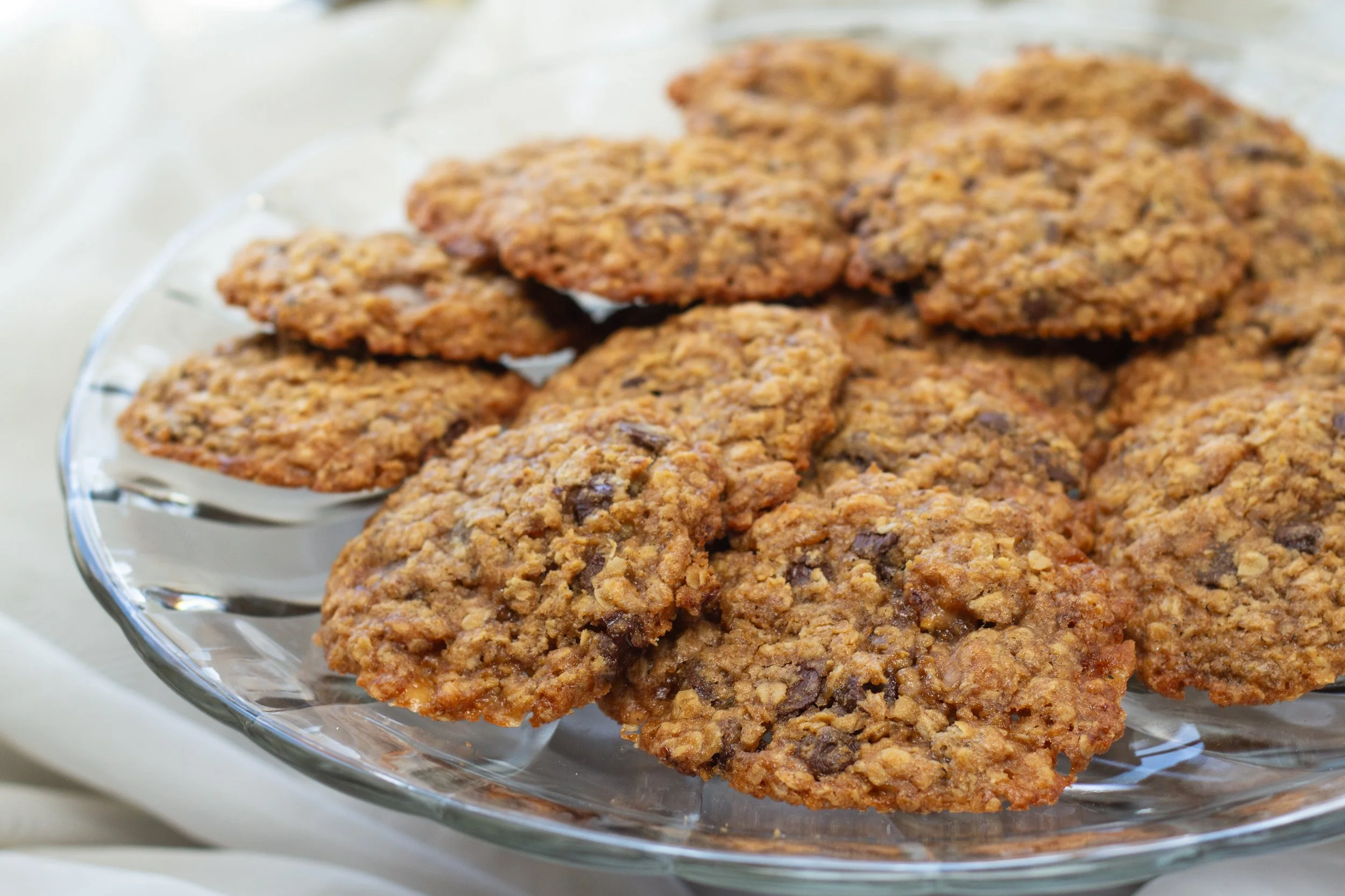 Oatmeal cookies with chocolate chips on a glass plate