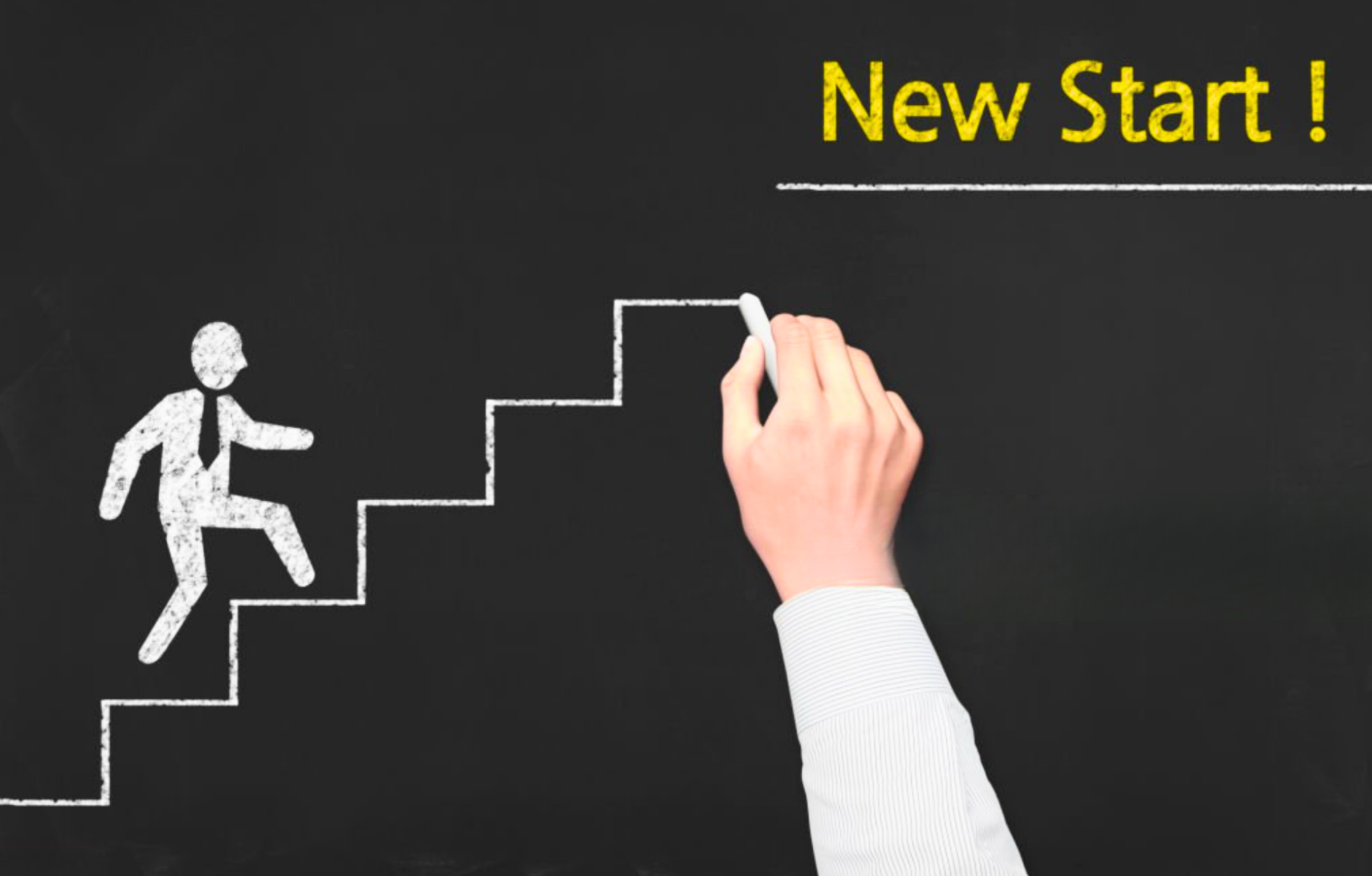 A hand drawing a staircase on a blackboard with chalk, with a stick figure of a person climbing the stairs, and the words 'New Start!' written in yellow at the top right.