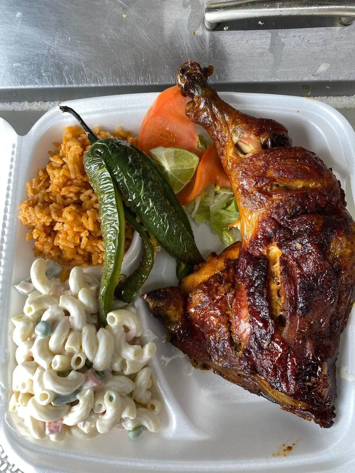 lapaisanita-starkville-chickenplate.jpg → Rotisserie chicken plate with rice, macaroni salad, roasted peppers, and fresh vegetables.