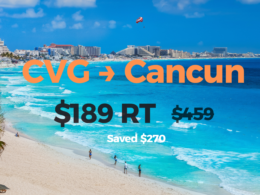 Beach scene with city buildings in the background, a parasail in the sky, and people walking along the sandy shore. Text overlay promoting a flight deal from CVG to Cancun for $189, originally $459, saving $270.