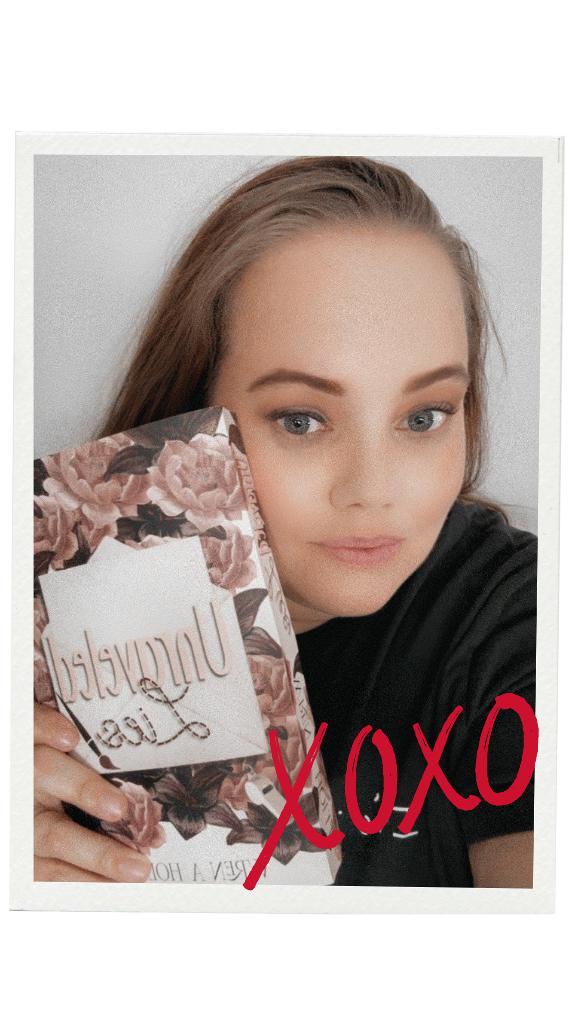 A woman with long light brown hair and light makeup is taking a selfie holding a book or box with floral design and the words "Unforgettable Love" on it. She is wearing a dark top, and there are red handwritten "XOXO" text over the photo.